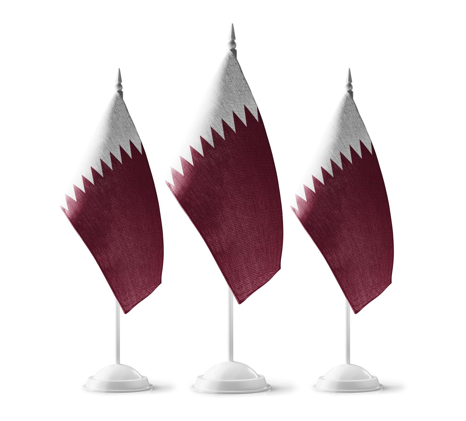 Small national flags of the Qatar on a white background.