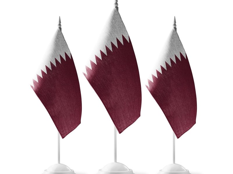 Small national flags of the Qatar on a white background.
